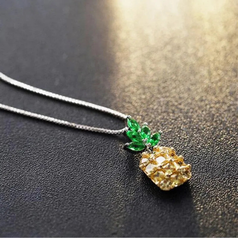 Silver geometric pineapple diamond pendant necklace on an adjustable chain.