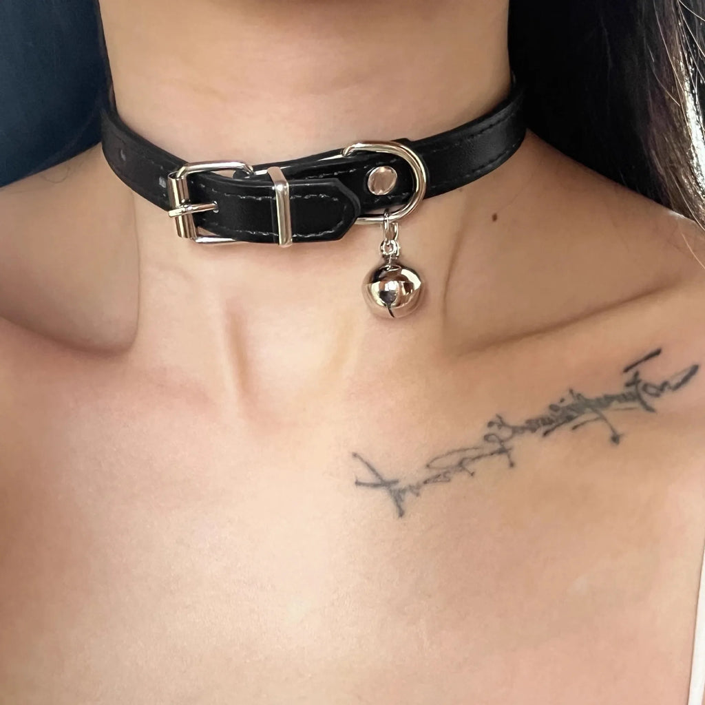 Black leather dog collar with brass bell charm in three designs: LD leather, bone pattern, and cat paw