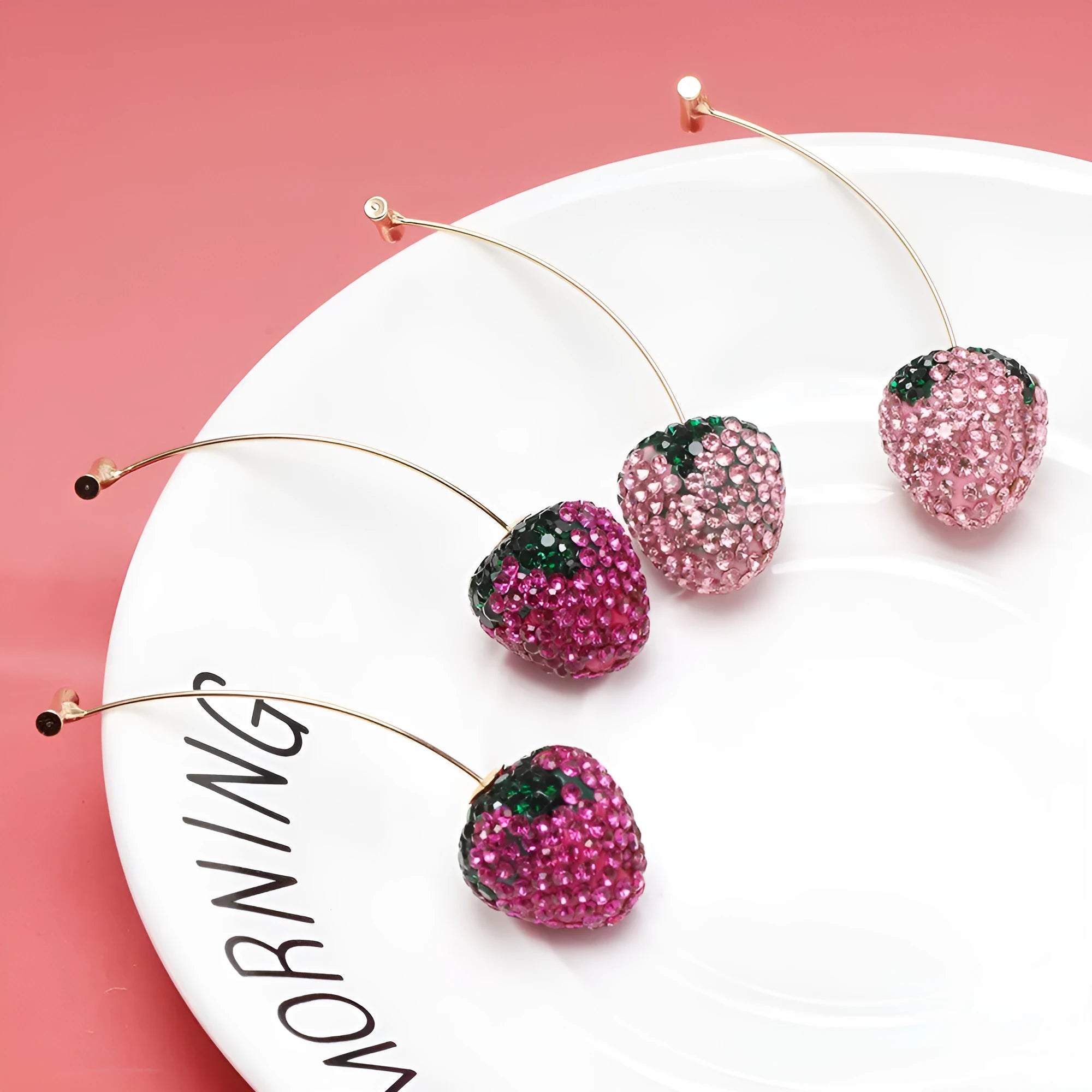 Geometric strawberry-shaped zinc alloy earrings with spot drill texture in red colour.