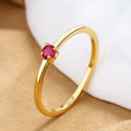 Women's copper fine circle ring with a single diamond in a geometric setting, shown on a hand.