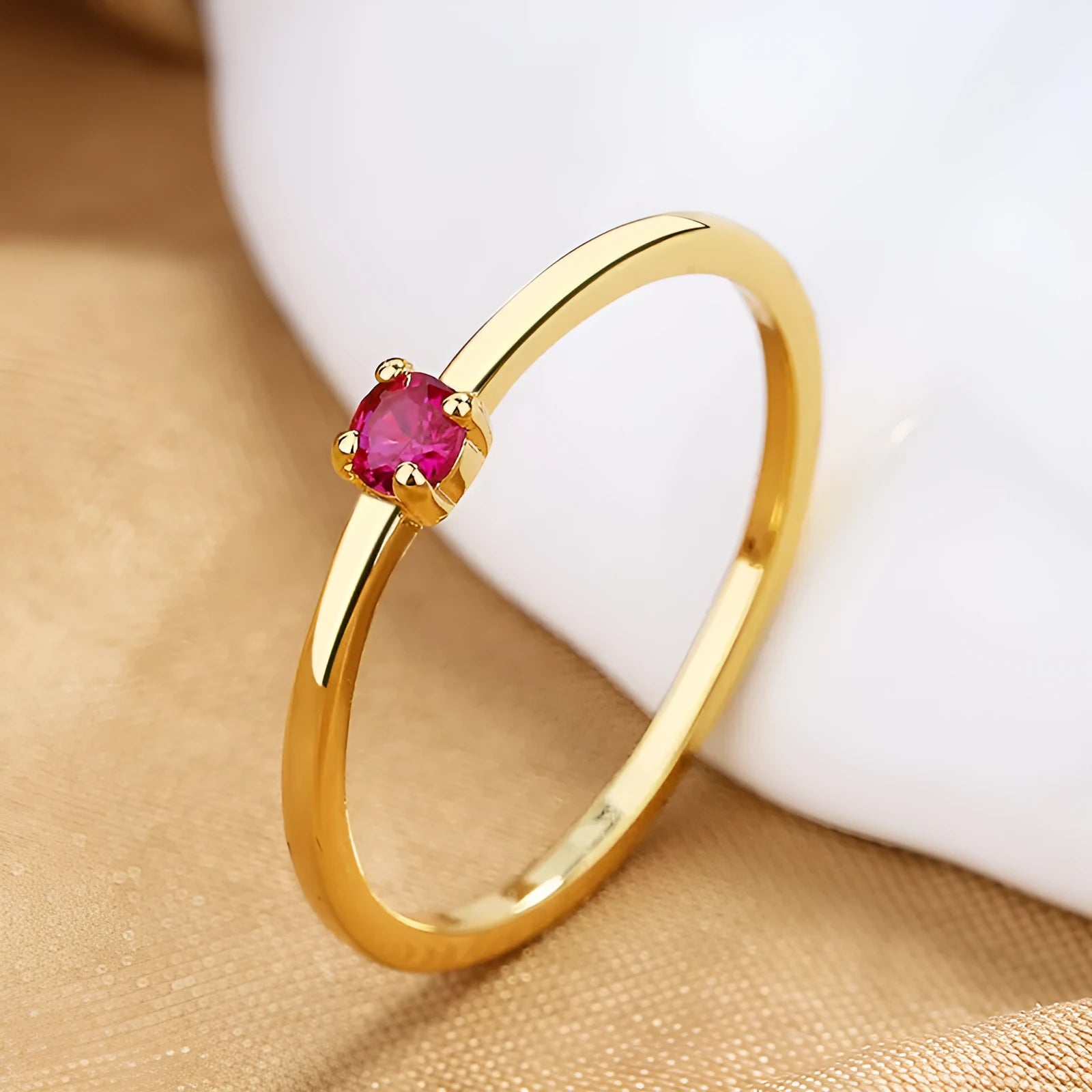 Women's copper fine circle ring with a single diamond in a geometric setting, shown on a hand.