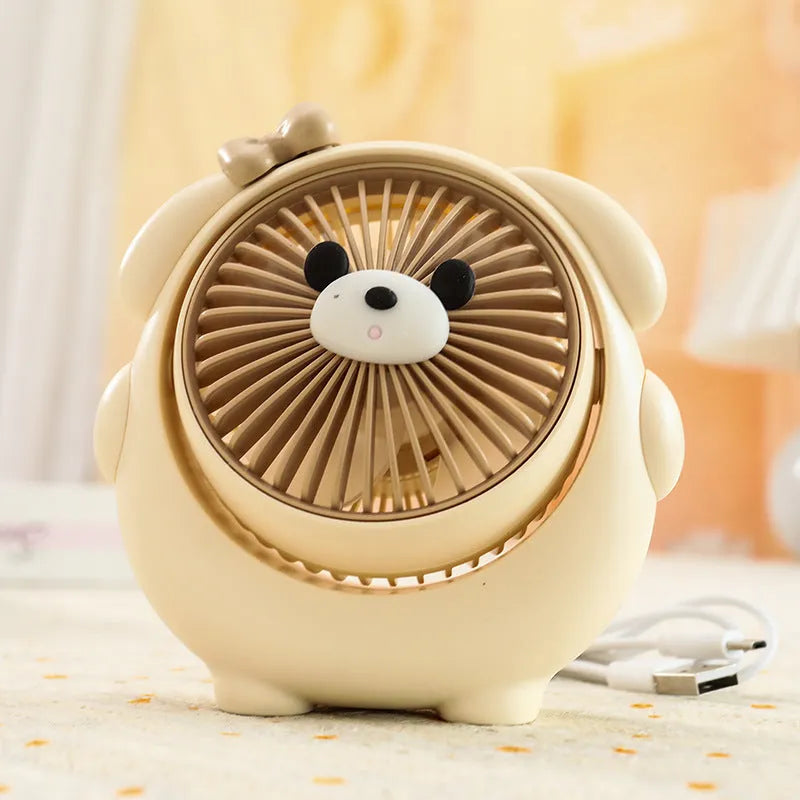 USB desktop electric fan in one of six colours including bear brown and puppy designs on a desk.