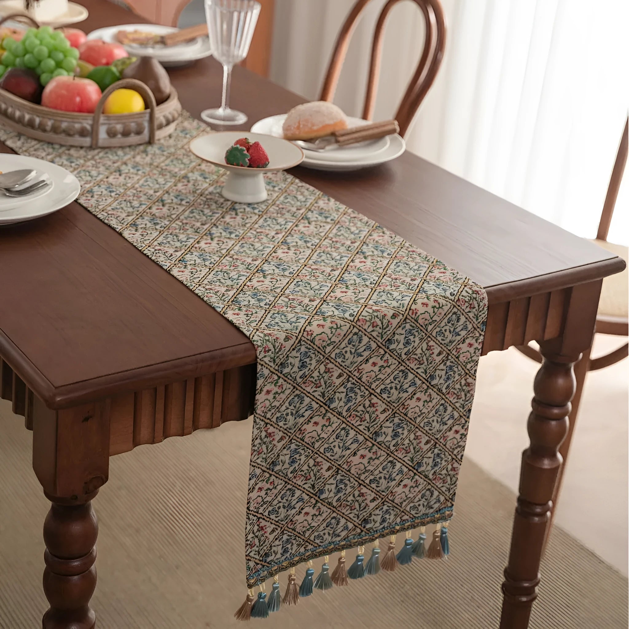 Dark blue Nordic Jacquard table runner with bouquet design and tassels laid on a wooden table.