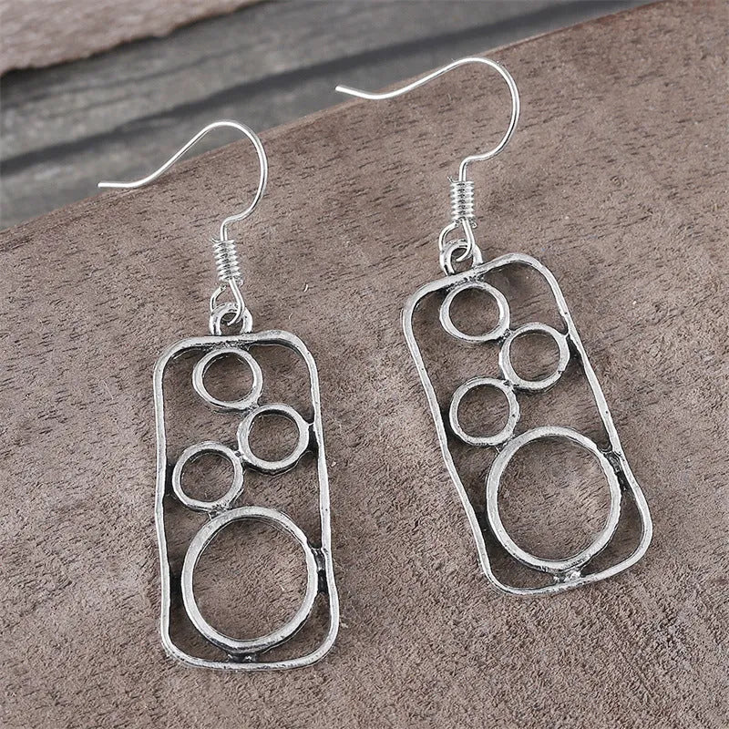 Geometric alloy earrings with round ring design and irregular square shape in antique silver colour