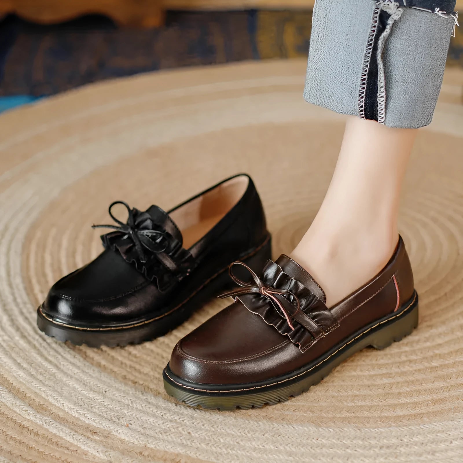 Black women's leather shoes with chunky flat heel, round toe, and low-top design on a plain background.