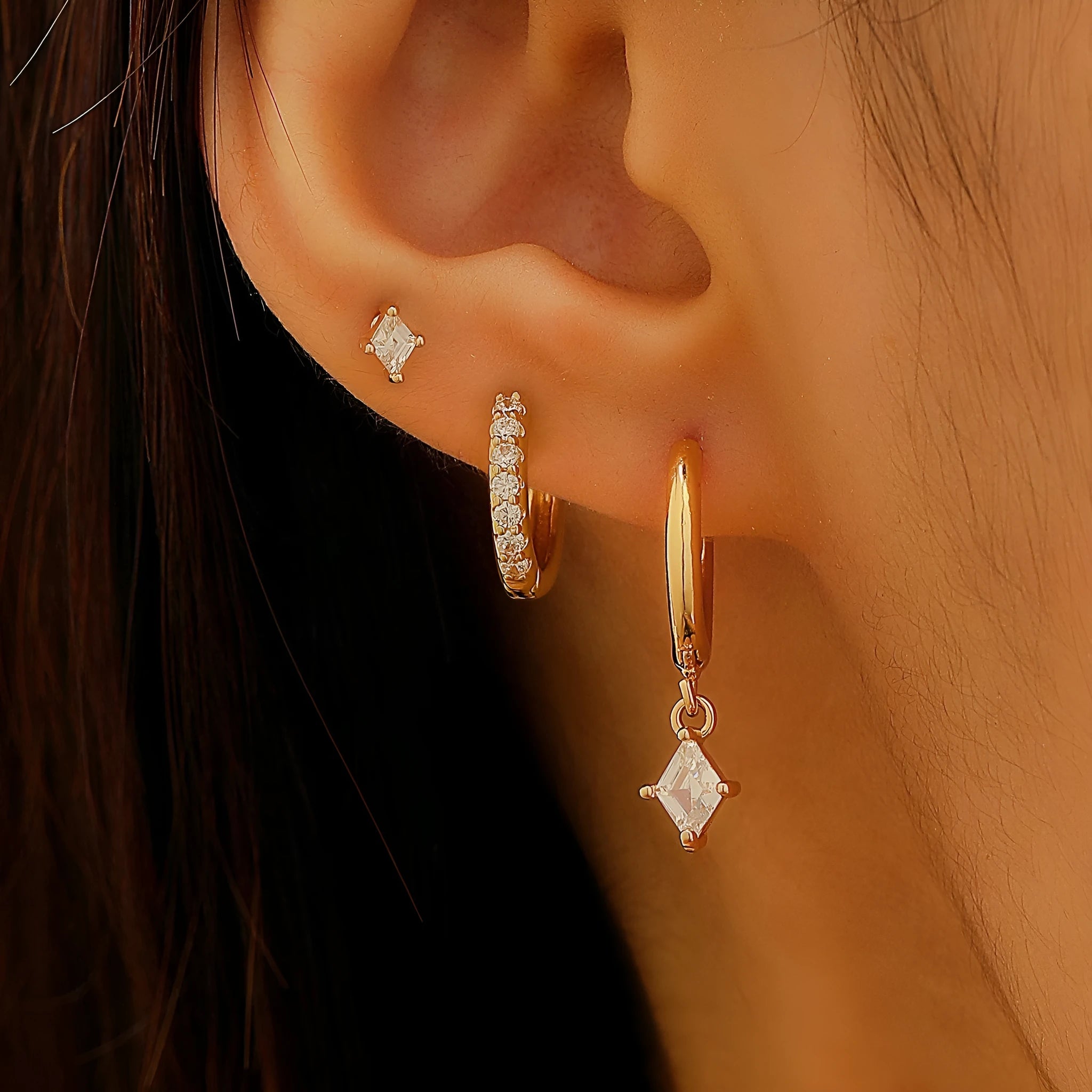 Ladies three-piece earring set with geometric designs and zircon accents in gold or white finish