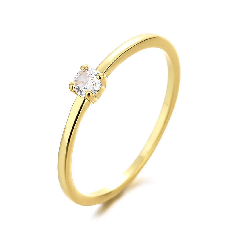 Women's copper fine circle ring with a single diamond in a geometric setting, shown on a hand.