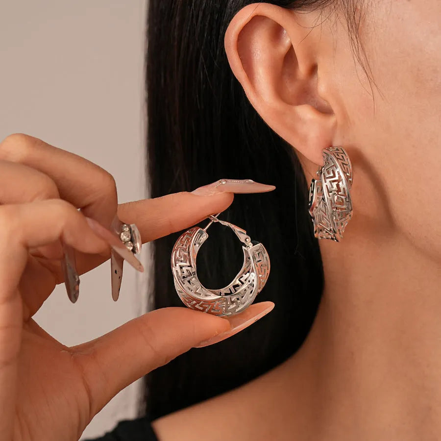 Geometric hollow stud earrings with twisted round design in gold or silver finish