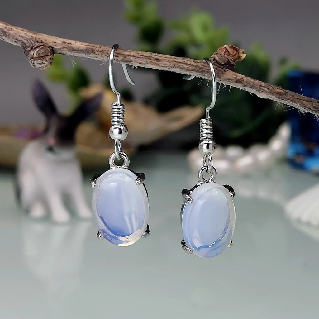 Opal earrings with retro moonstone cross design and ellipse elements in drop shape