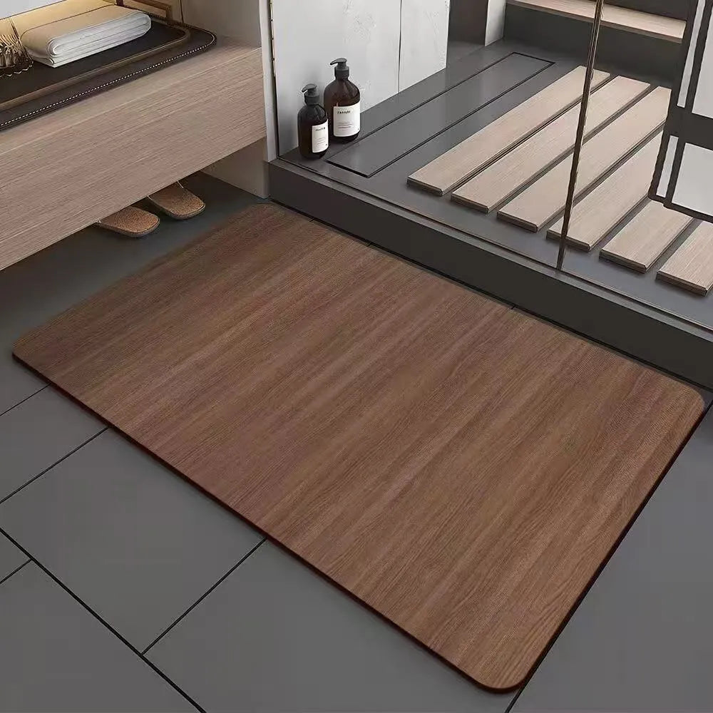 Square diatomite bathroom floor mat with geometric print in a wood grain colour on a tiled floor.