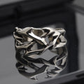 Copper geometric ring with thorn and flower design featuring adjustable opening mechanism
