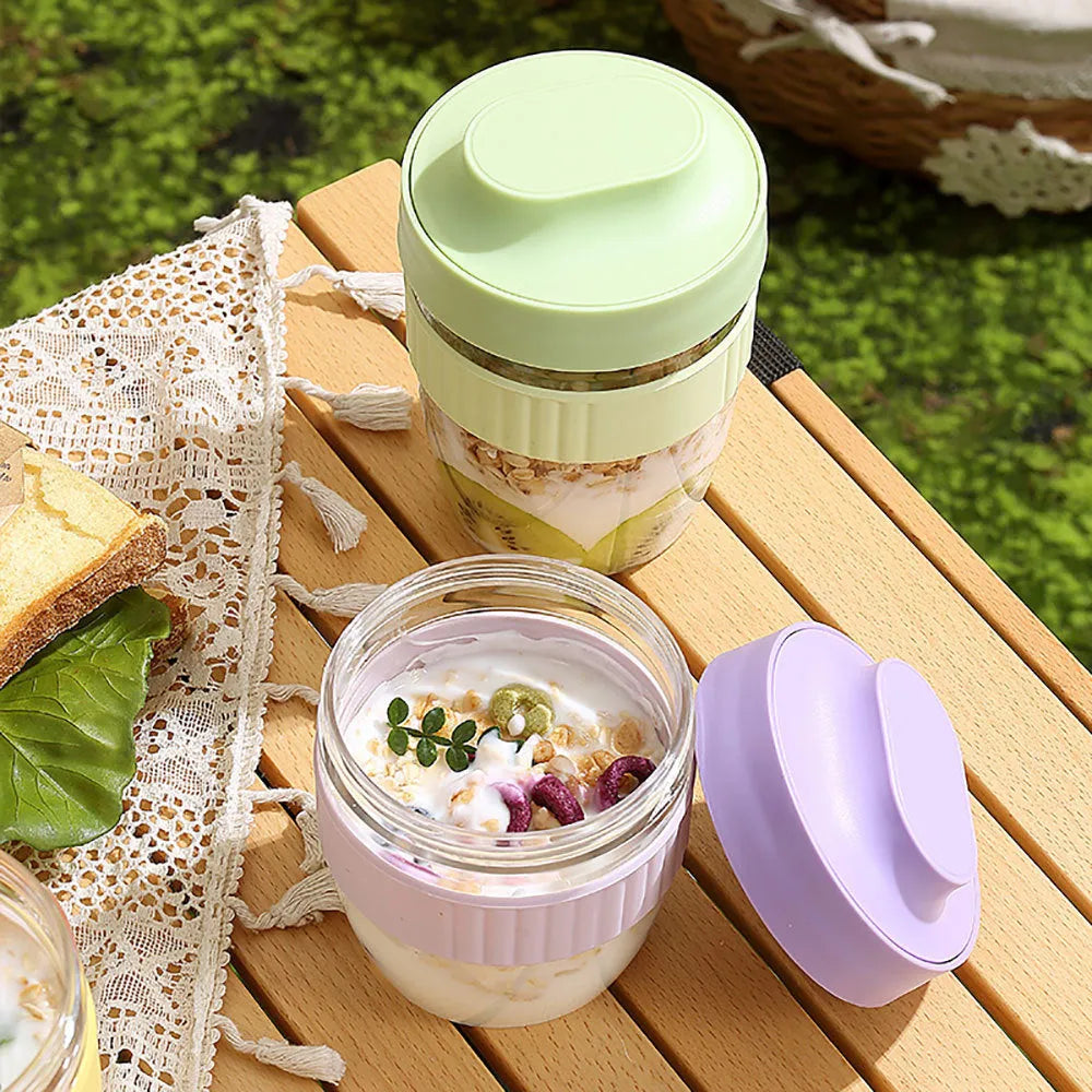 Green plastic salad cup with clear lid and spoon, sealed leak-proof design.
