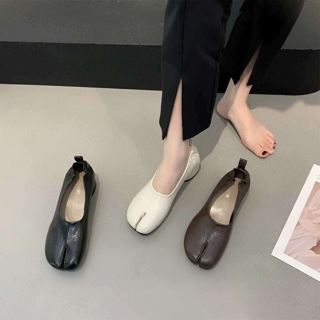 Women's apricot low chunky heel pumps with split toe and horseshoe peas detail on round toe.