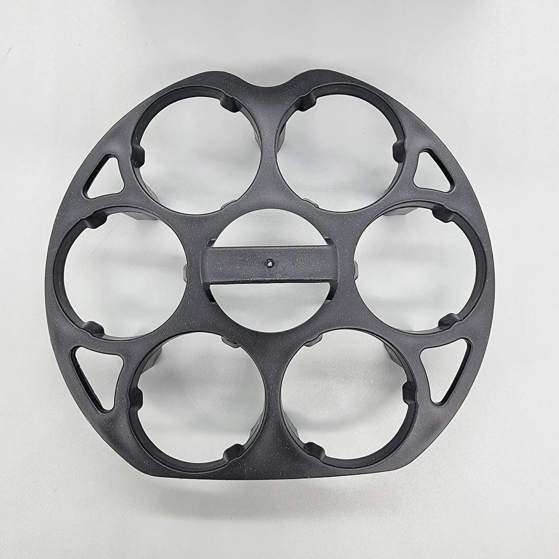 Black plastic egg holder cooking basket rack with modern design on a white background.