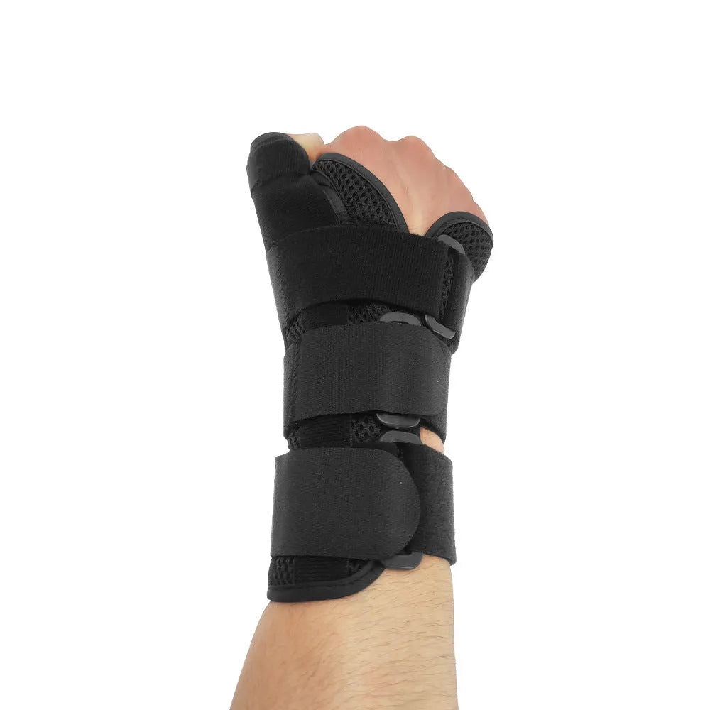 Carbon fibre style black sports wrist guard with grey edging and a thumb strap.