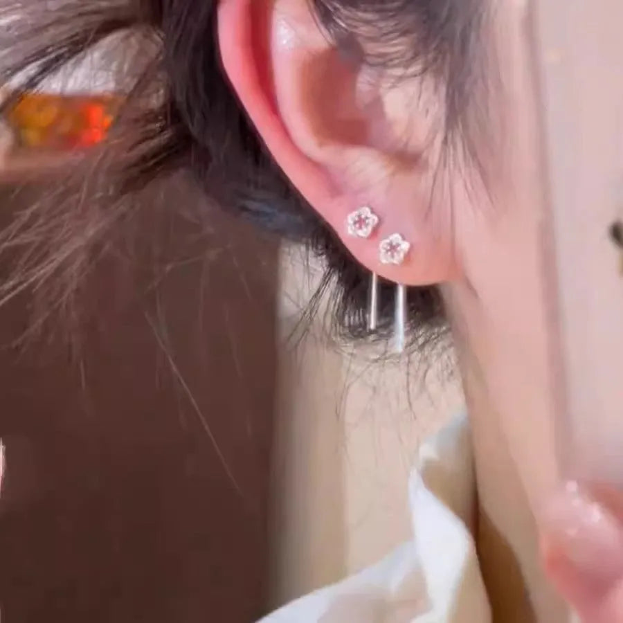 Silver colour flower hanging earrings with natural petal design and needle posts