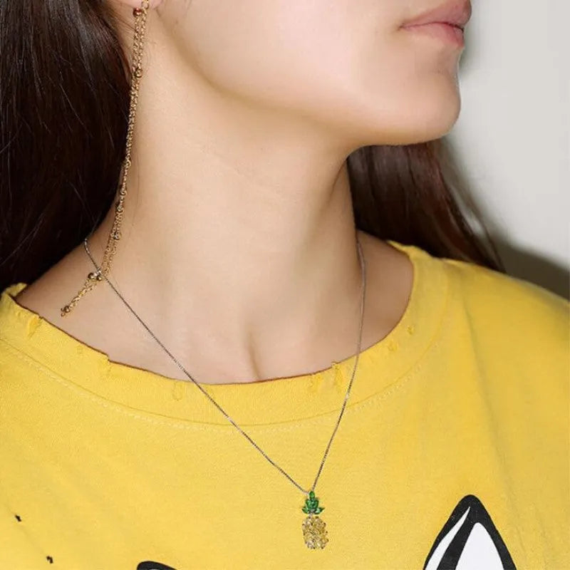 Silver geometric pineapple diamond pendant necklace on an adjustable chain.