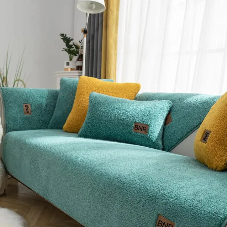 Lambswool sofa cover in solid blue colour on a three-seater sofa