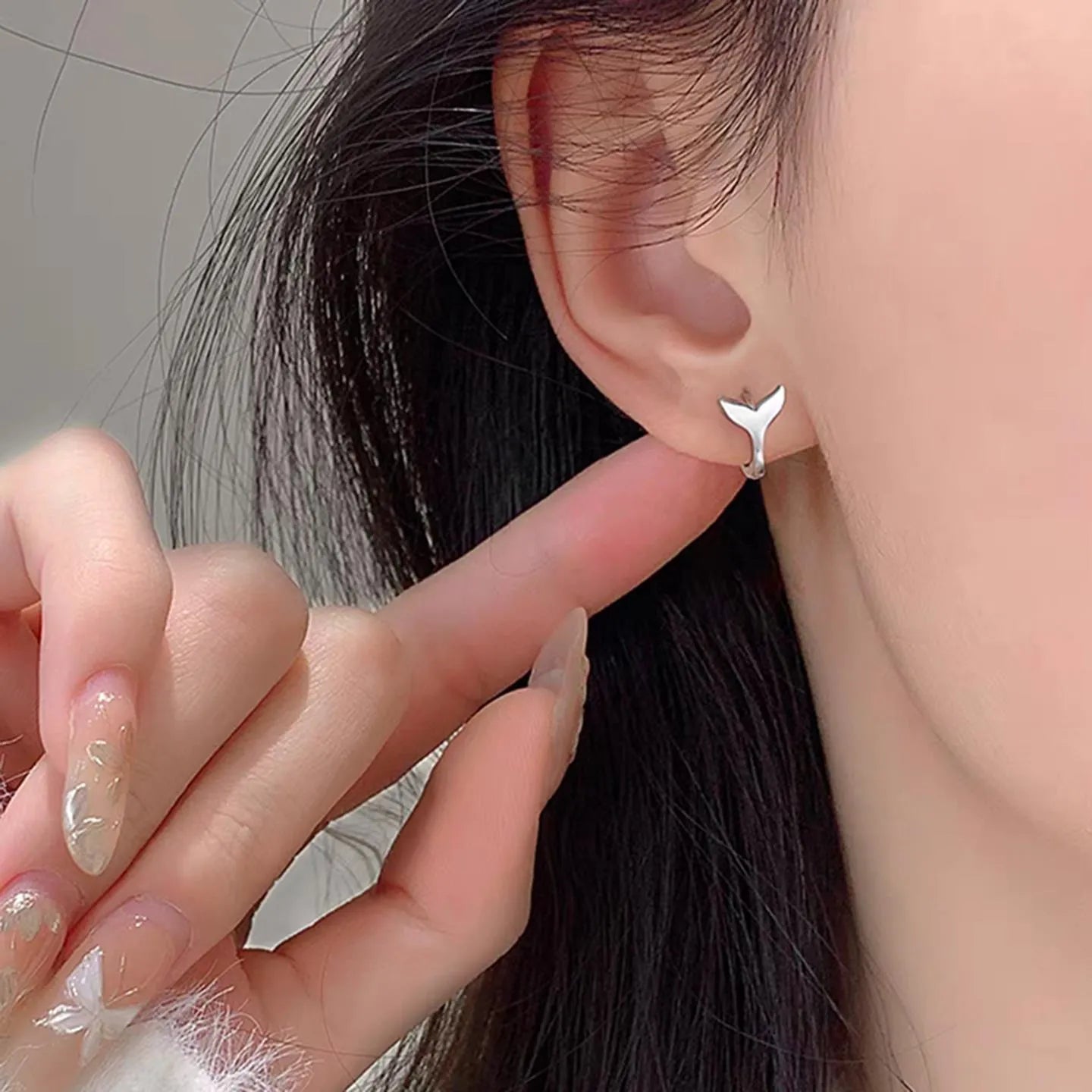 A pair of women's simple fishtail design earrings in an electroplated gold colour.