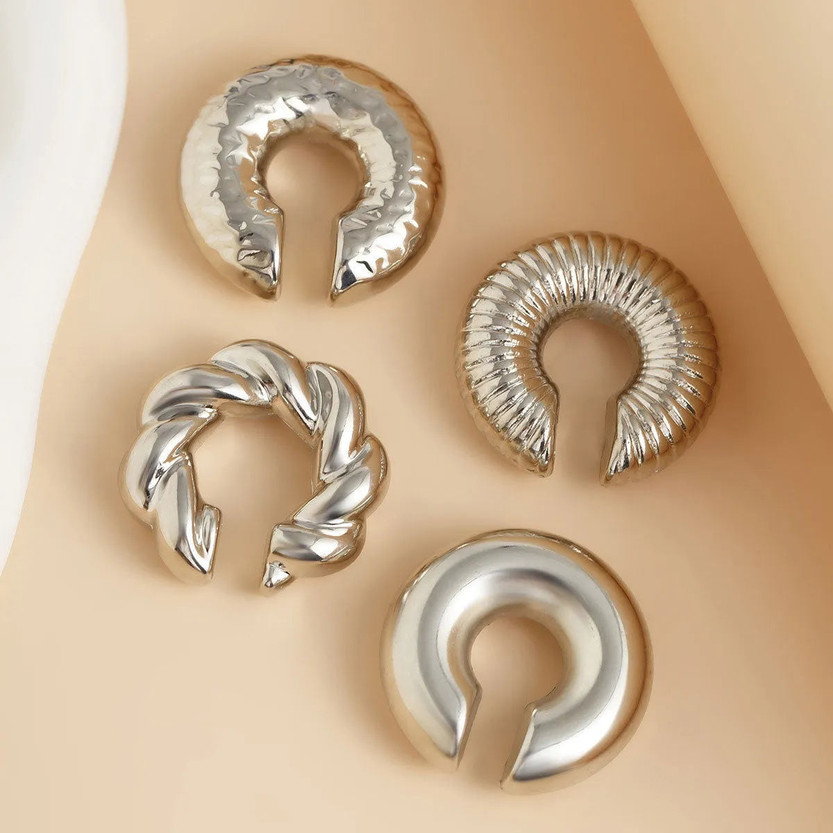 Geometric clip-on earrings for women in gold or silver tone, set of four pieces.