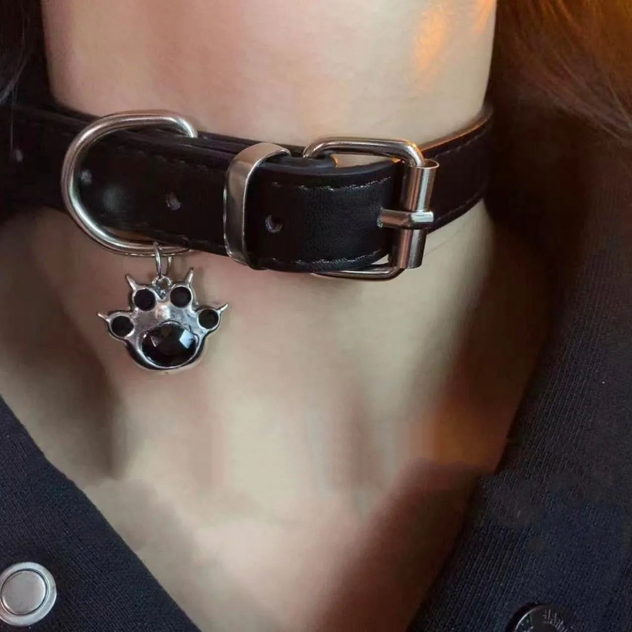 Black leather dog collar with brass bell charm in three designs: LD leather, bone pattern, and cat paw