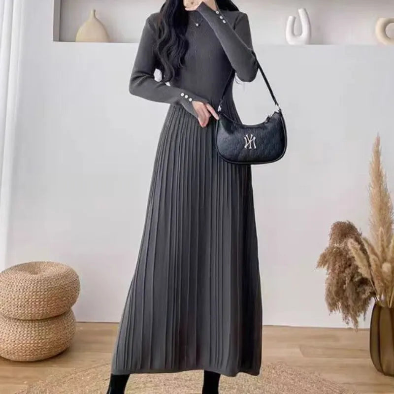 Women's beige high waist A-line knitted midi dress with regular sleeves on a mannequin.