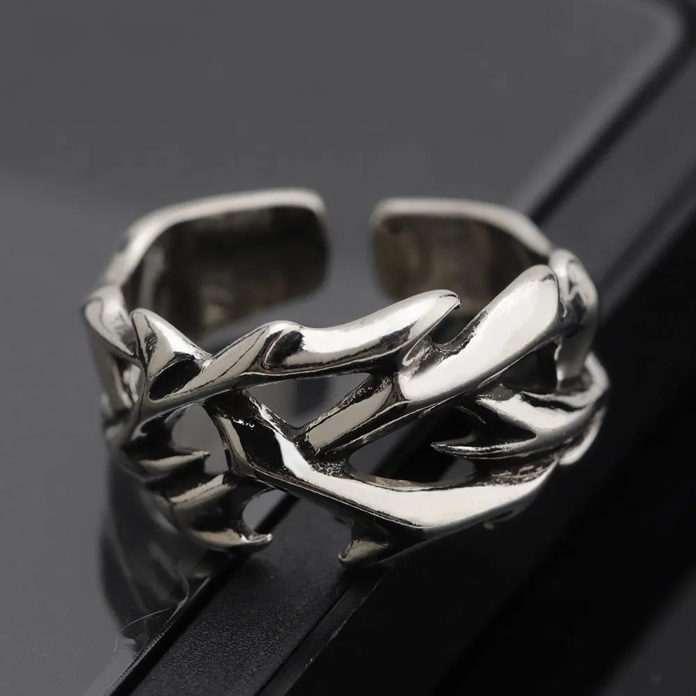 Copper geometric ring with thorn and flower design featuring adjustable opening mechanism