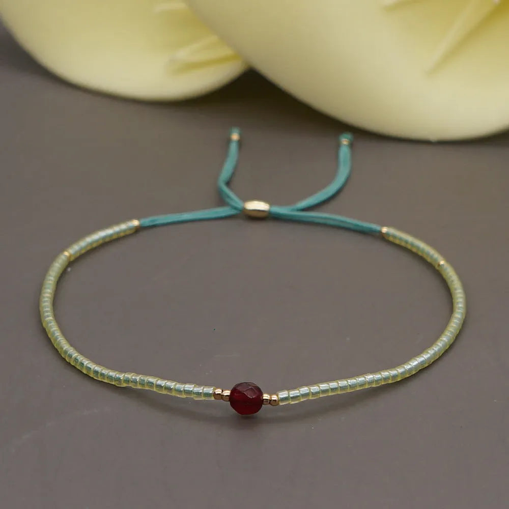 Women's handmade bohemian bracelet with semi-precious stone bead and colourful glass beads.