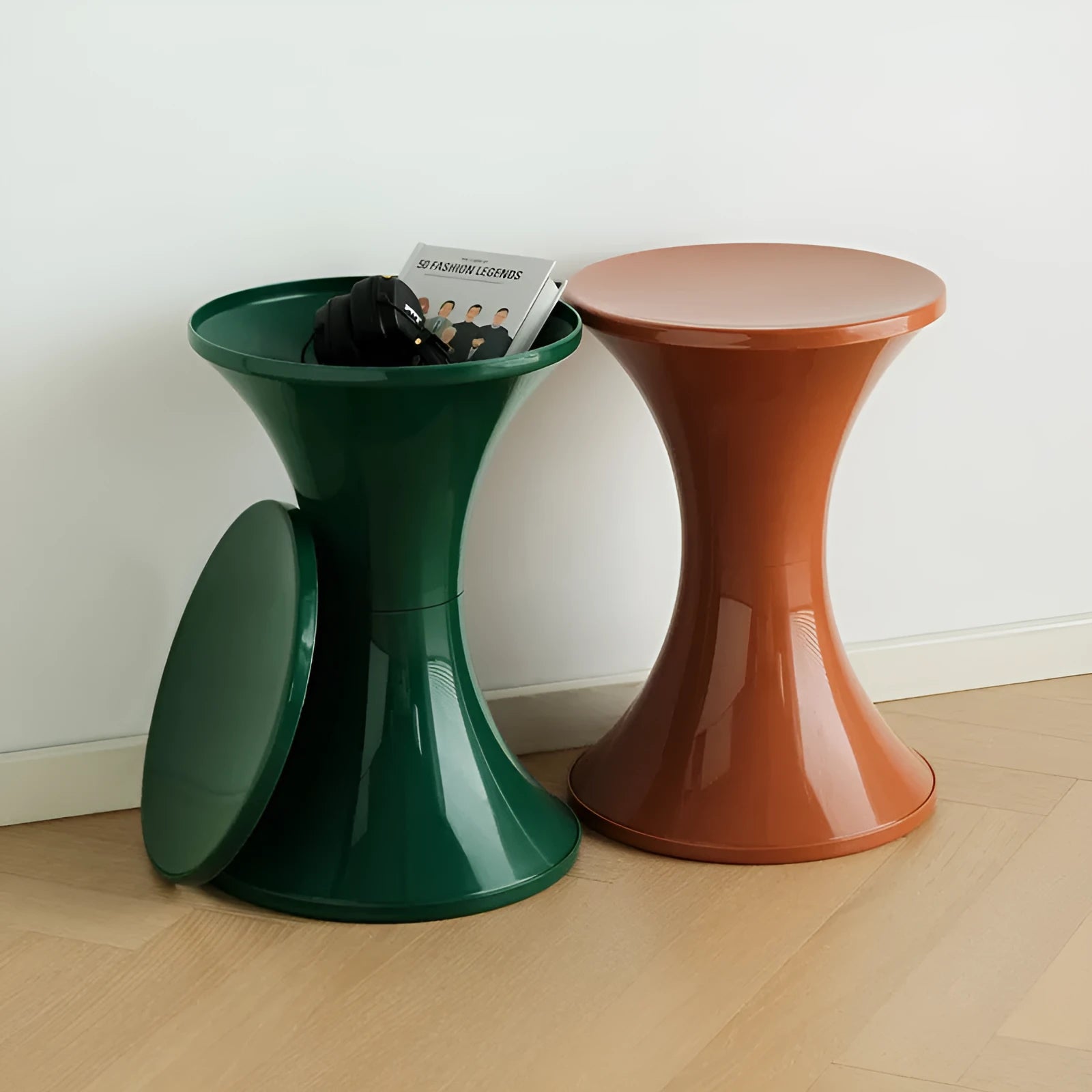 A plastic hourglass-shaped stool for changing shoes, shown in one of five available colours.