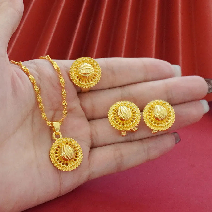 Gold-plated three-piece jewelry set showing necklace, earrings, and ring with a detailed flower design pendant.
