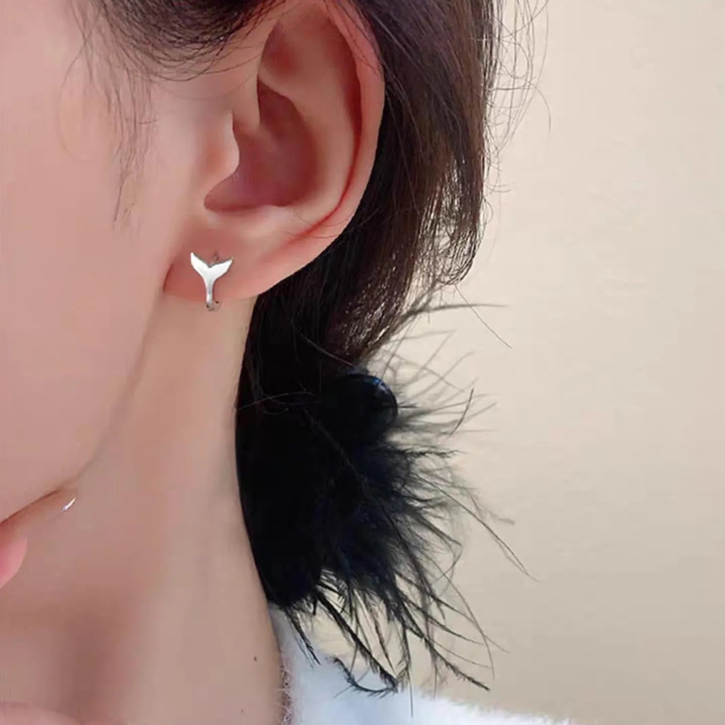 A pair of women's simple fishtail design earrings in an electroplated gold colour.