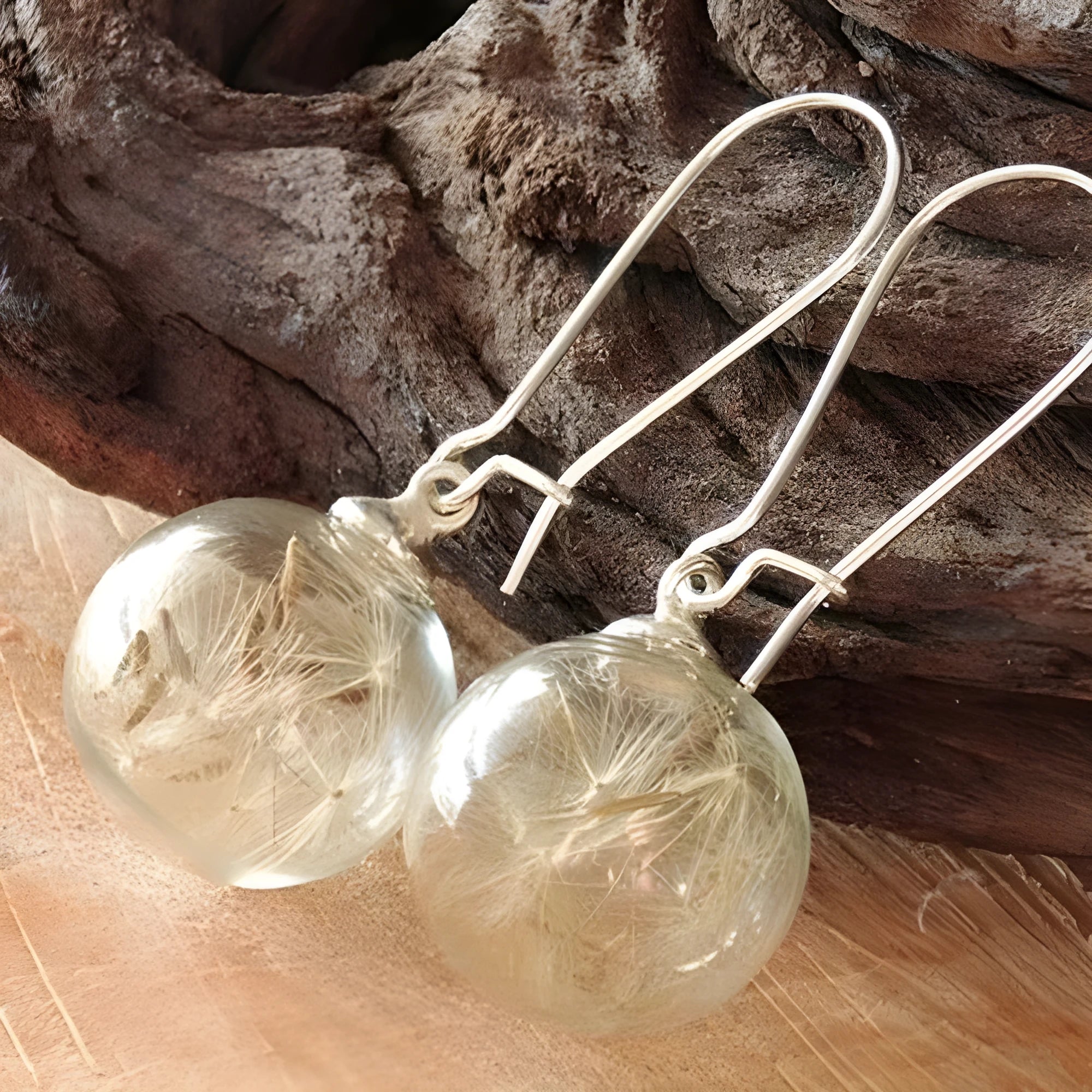 Transparent glass ball earrings with dandelion seed design and French hooks in silver or bronze finishes