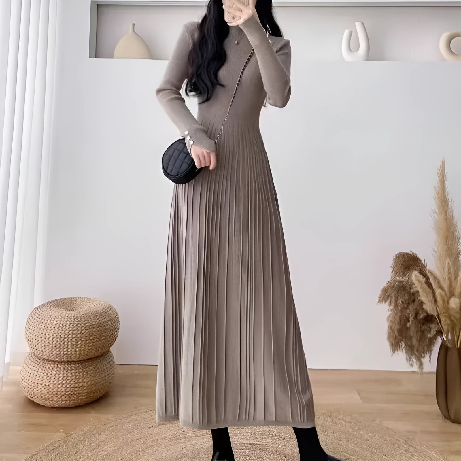 Women's beige high waist A-line knitted midi dress with regular sleeves on a mannequin.