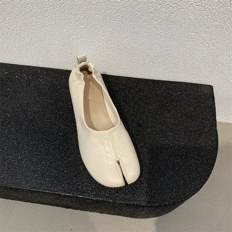 Women's apricot low chunky heel pumps with split toe and horseshoe peas detail on round toe.