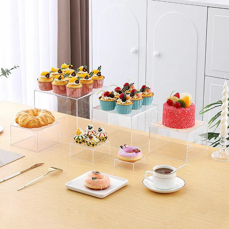 White plastic cube dessert display stand with six modular pieces arranged on tabletop
