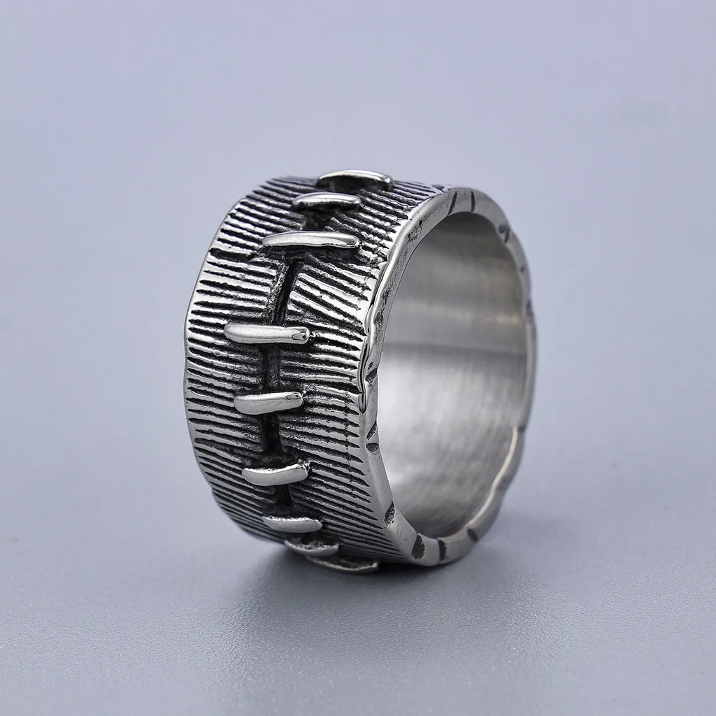 Dark punk geometric U-shaped double ring in titanium steel on a solid background