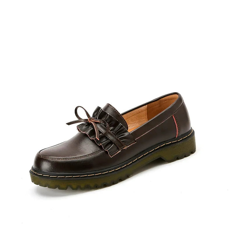 Black women's leather shoes with chunky flat heel, round toe, and low-top design on a plain background.