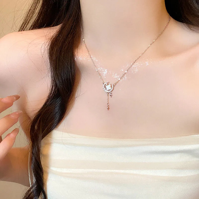 Women's star moon necklace with zirconium accents on adjustable chain in gold or silver finish