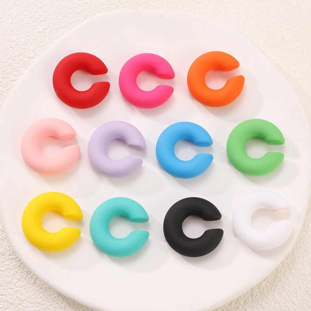 Matte finish geometric C-shaped clip-on earrings in candy colours for women without pierced ears