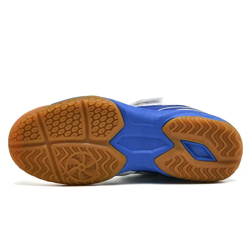 White and blue low top badminton shoes with a ribbed sole and breathable PVC upper.