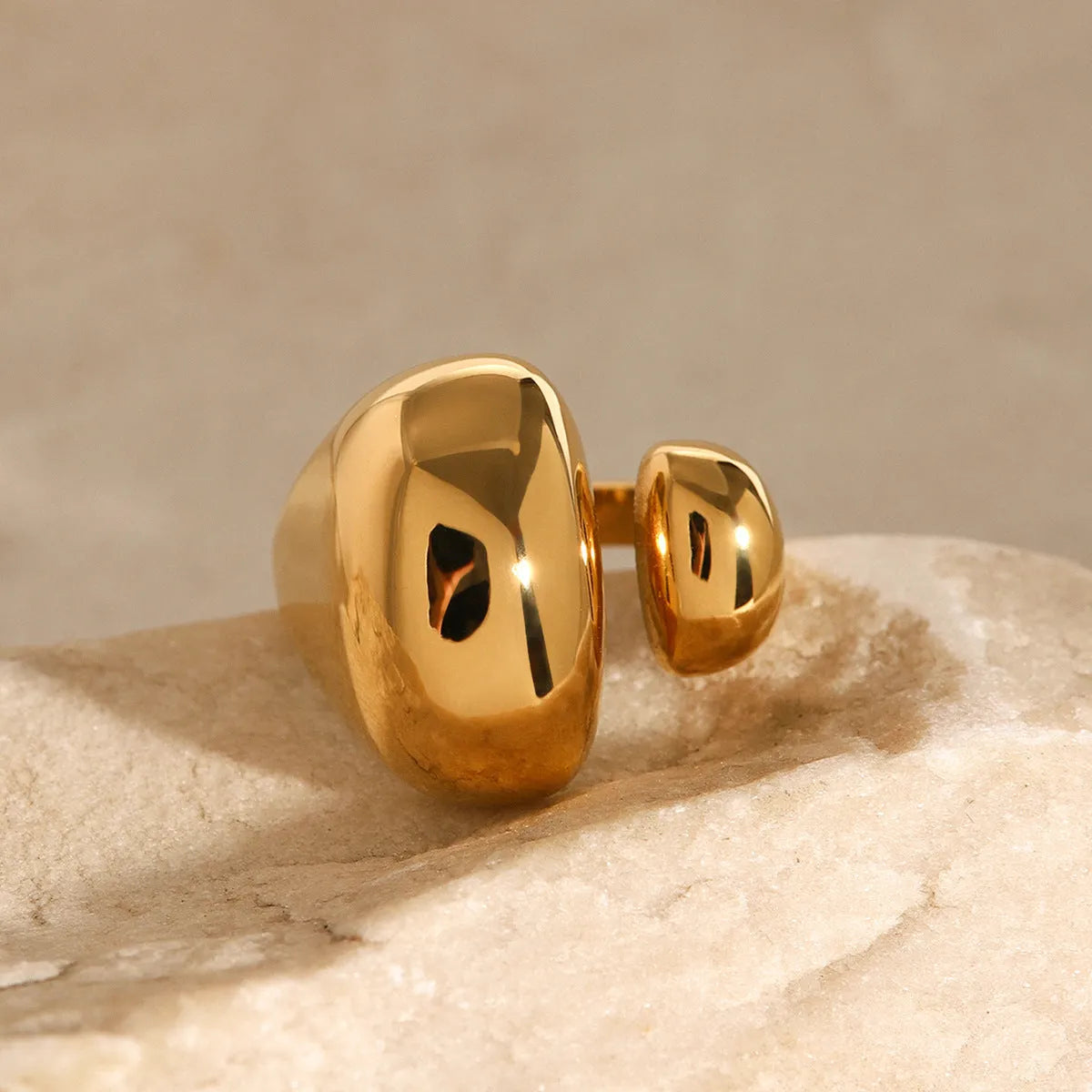 Women's exaggerated geometric stainless steel open ring with electroplated finish.
