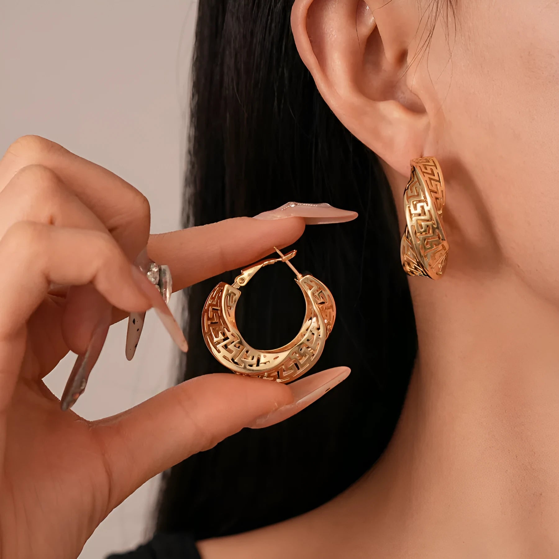 Geometric hollow stud earrings with twisted round design in gold or silver finish