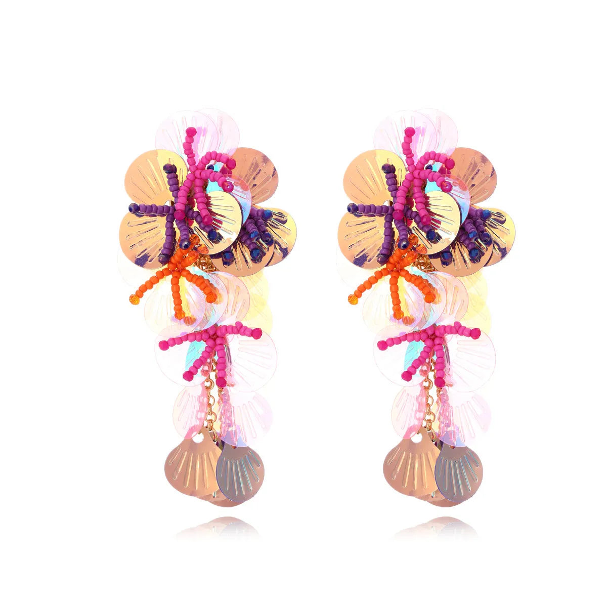Handmade exaggerated floral earrings with colourful string beads and leaves on a purple background.