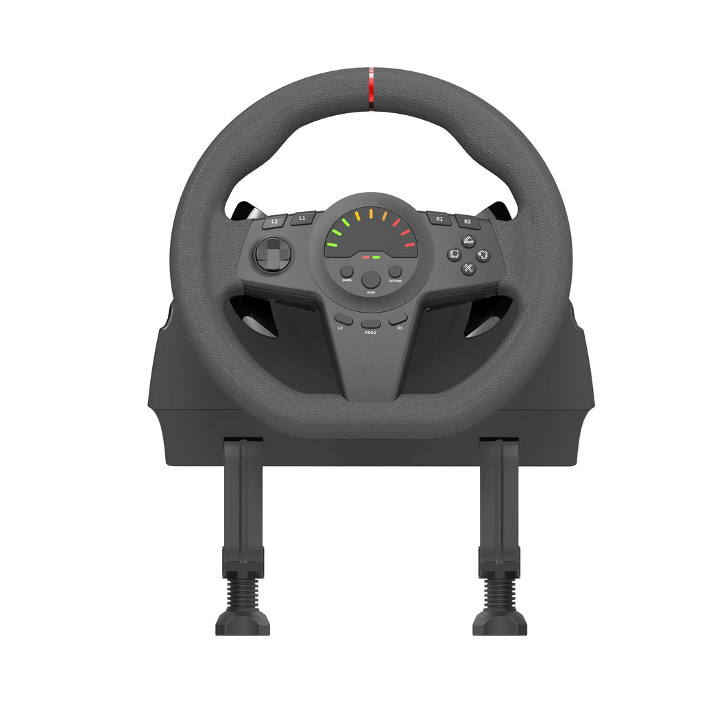 Black multi-platform gaming steering wheel with two pedals and a USB cable on a desk.