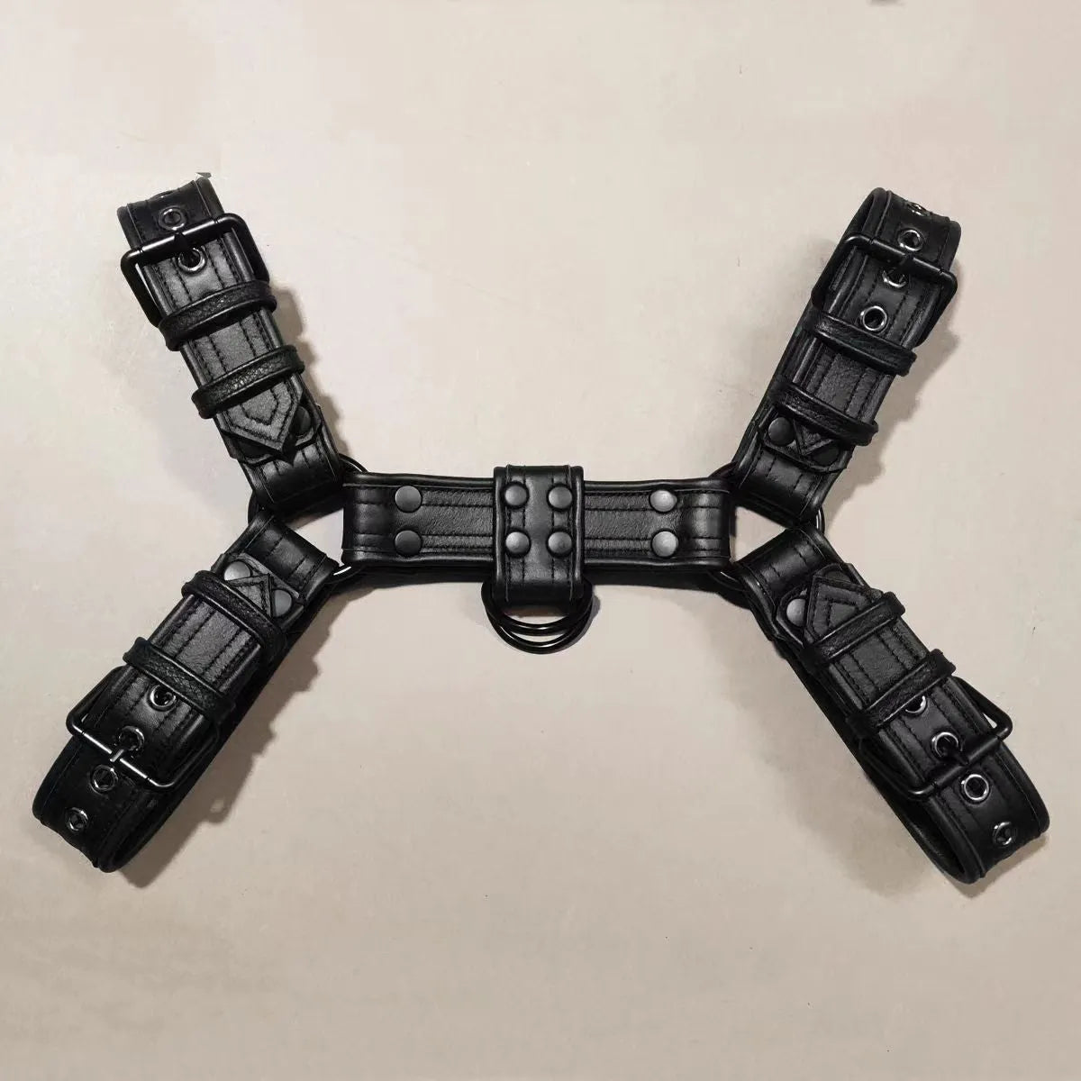 Black leather chest muscle bondage strap with metal buckle and rivets on a mannequin