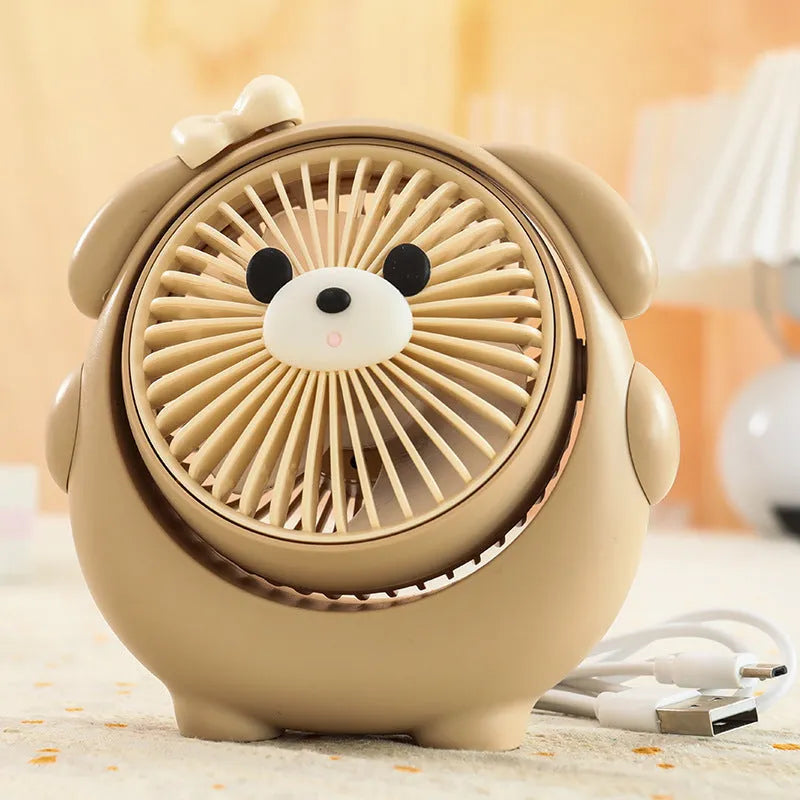 USB desktop electric fan in one of six colours including bear brown and puppy designs on a desk.
