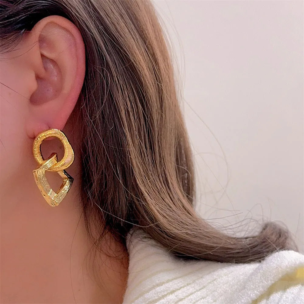 Geometric circle pendant earrings with 3.4cm drop in gold or silver tone electroplated copper