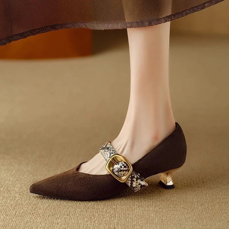 Black and brown women's pointed toe stiletto heels with a buckle fastener and mid-height heel.