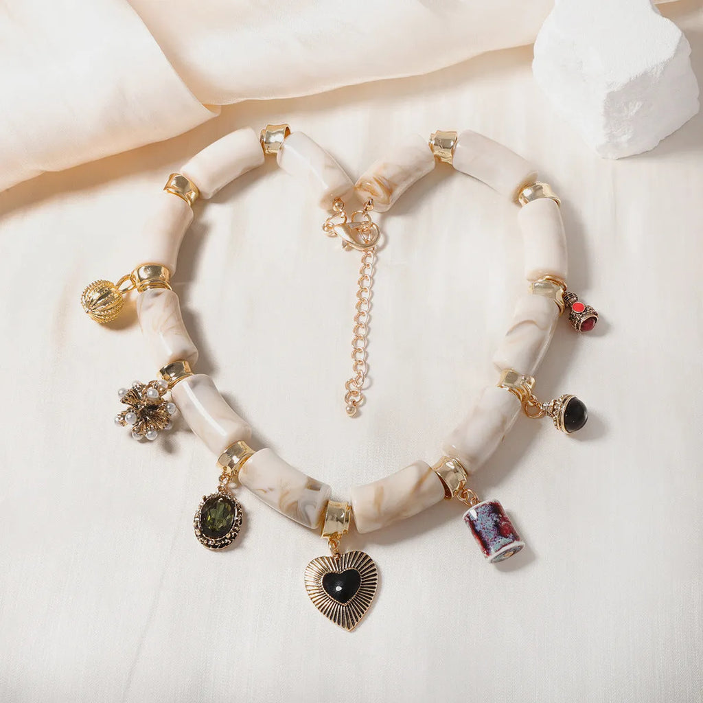 Electroplated heart-shaped resin necklace with bamboo design elements