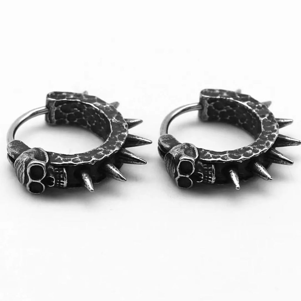 A pair of black alloy earrings with a geometric motorcycle punk design on a white background.